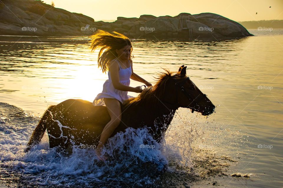 Riding her horse ,at the beach into the sunset ,action girl in her White dress at her horse โค๏ธ๐งก๐๐๐๐Sunset,sumner and fun.