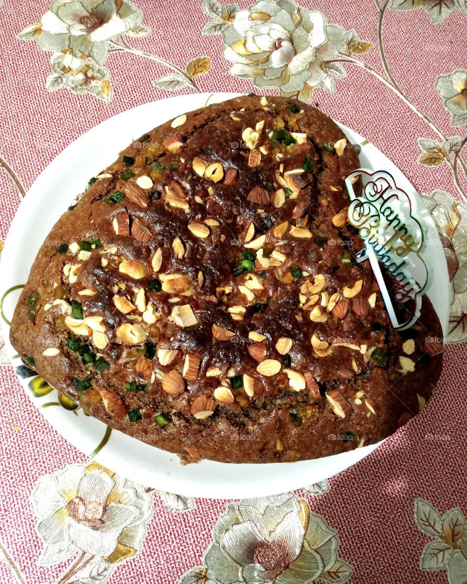 Birthday cake it's a home made testy and pretty cake it's a chocolate cake make in own use dryfruit on cake as a toppings so testy