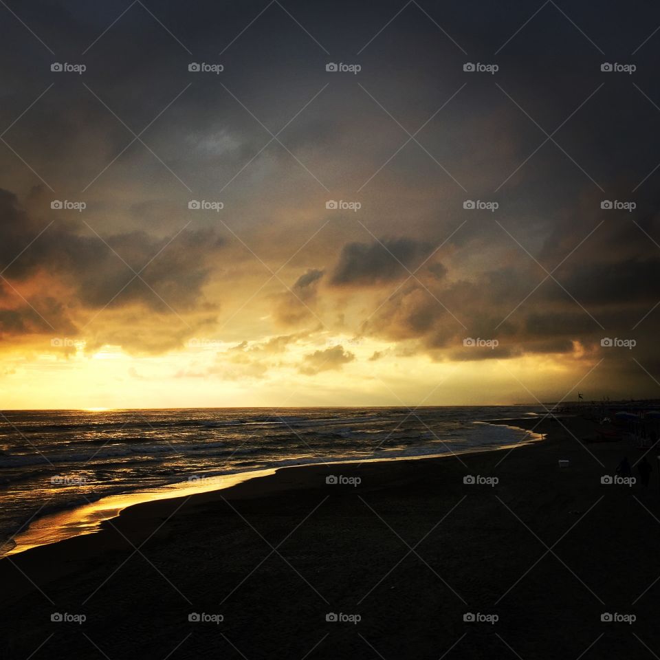 Beach during sunset with dramatic sky