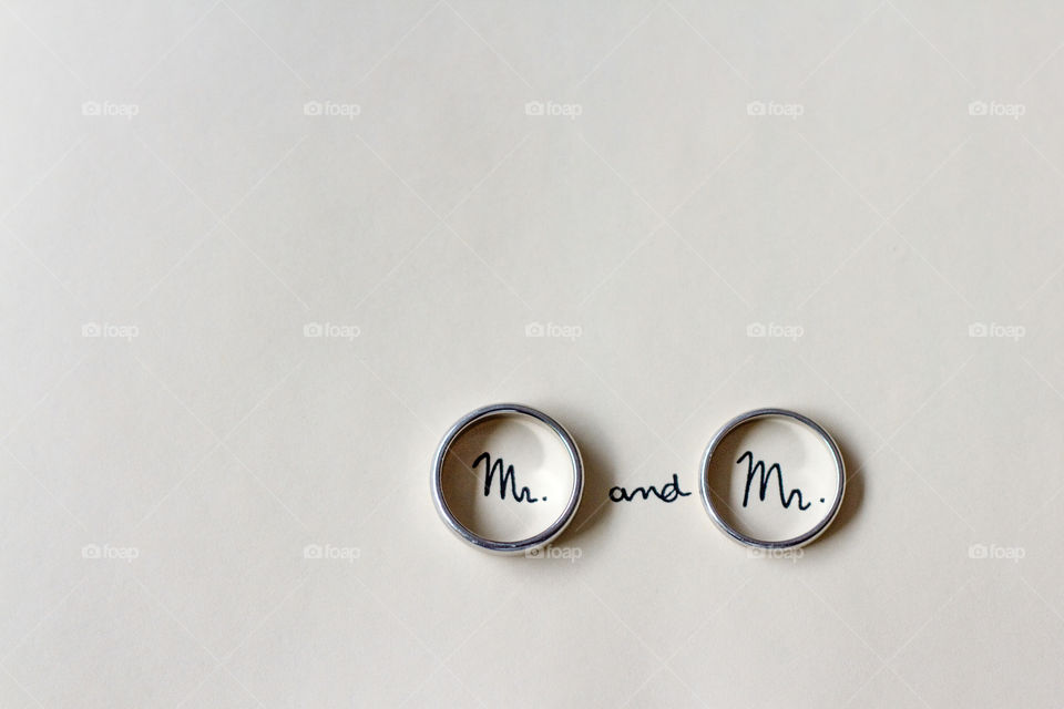 Men's rings at a gay wedding with the words Mr written inside