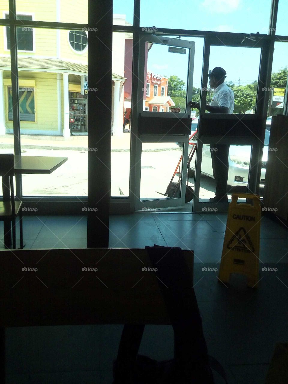 the picture you are looking at the is very simple this man is standing outside of is work place