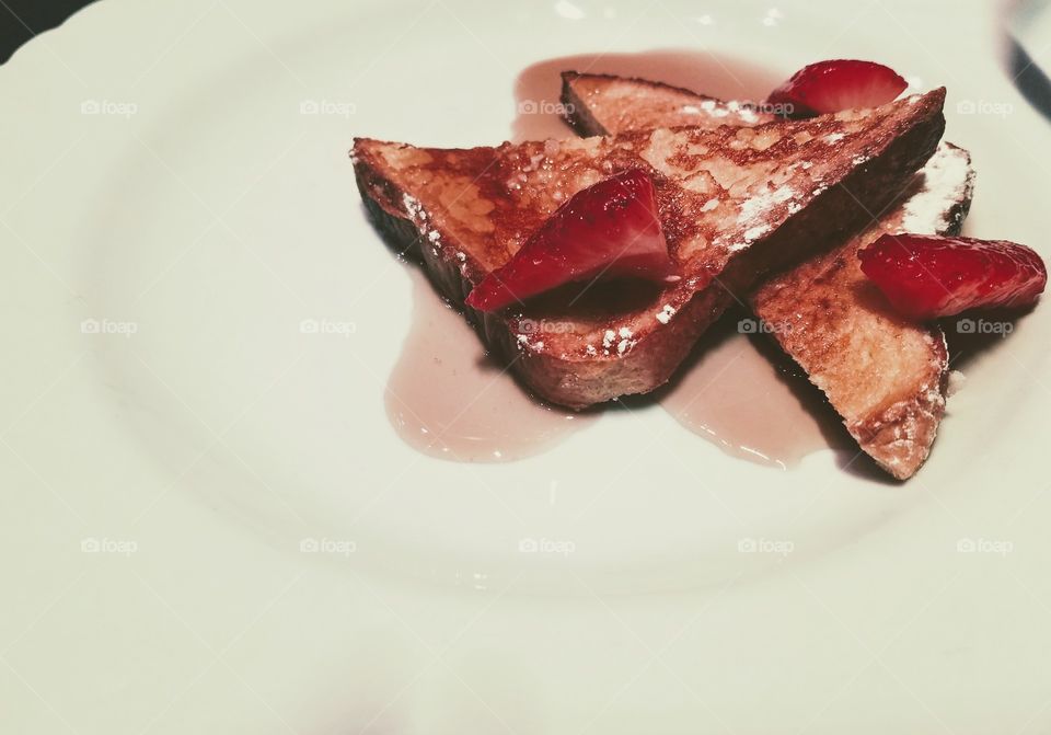 Simple Tasty French Toast with Strawberries, Powdered Sugar and Syrup