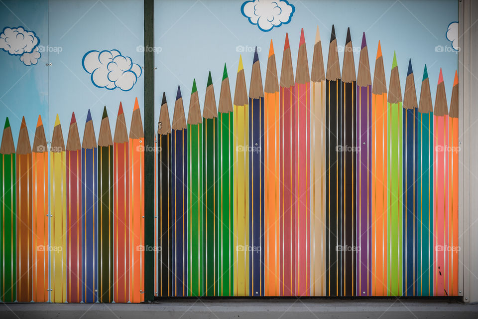 Kindergarten fence with colored pencils