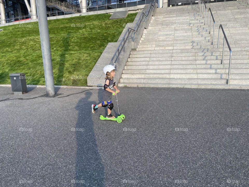 Boy riding on a scooter 