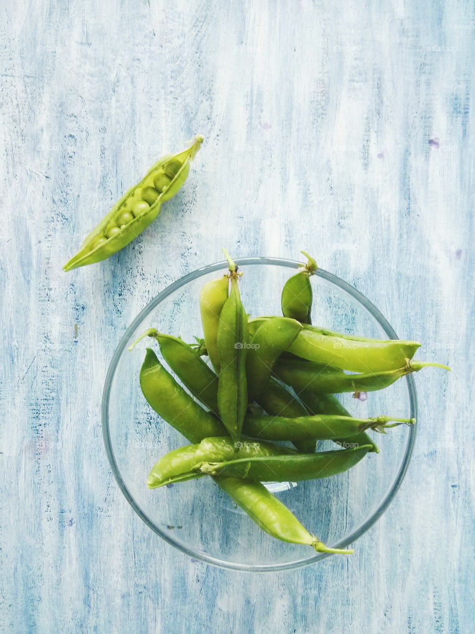 Green peas. Green peas on blue wooden background