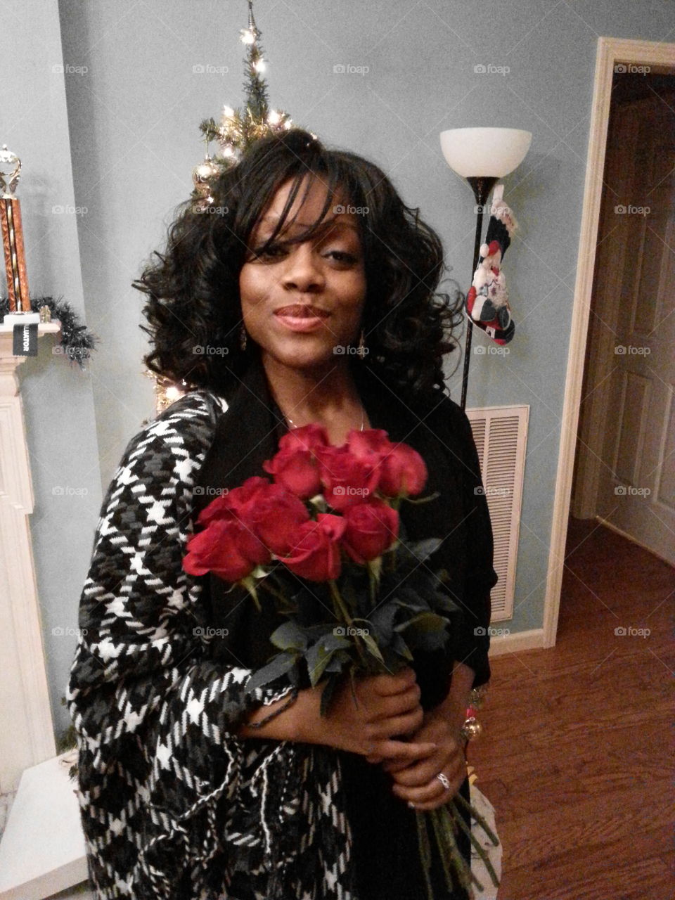 African woman holding rose flower bunch