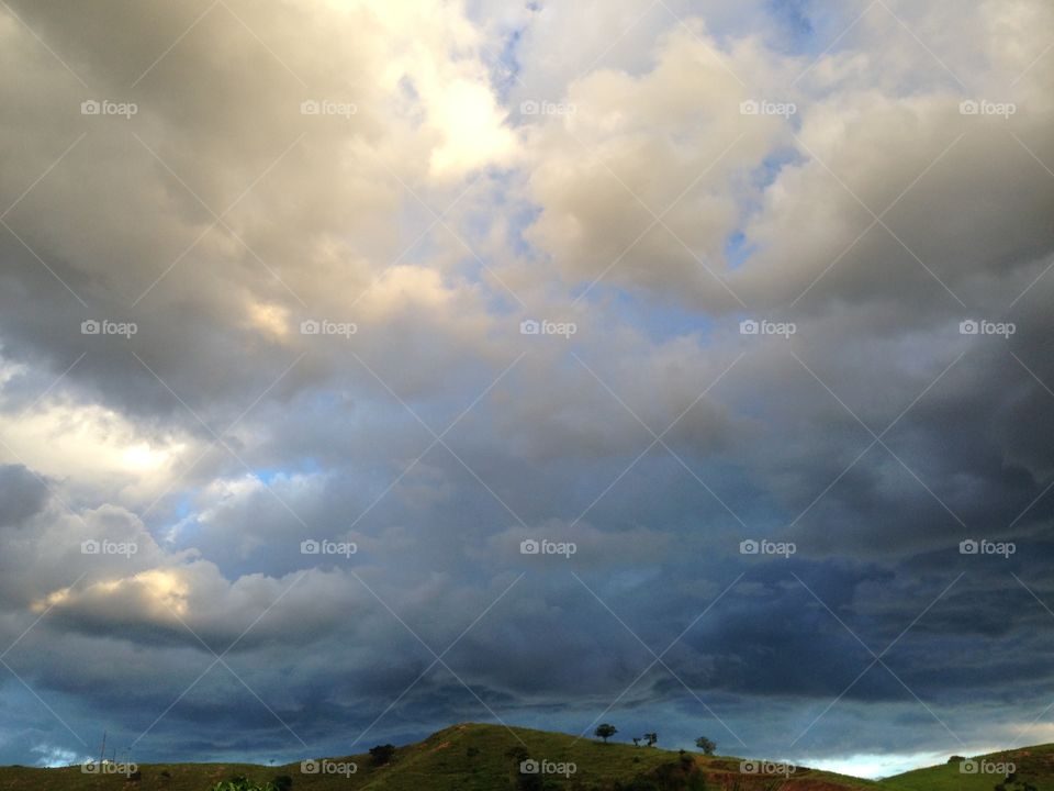 Scenic view of storm cloud over hill