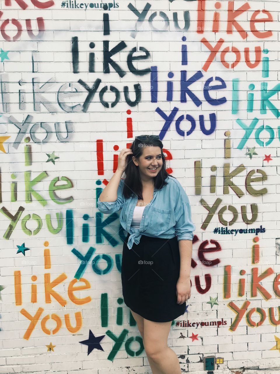 Girl photographed in front of ‘i like you’ wall art located in Minneapolis, Minnesota.