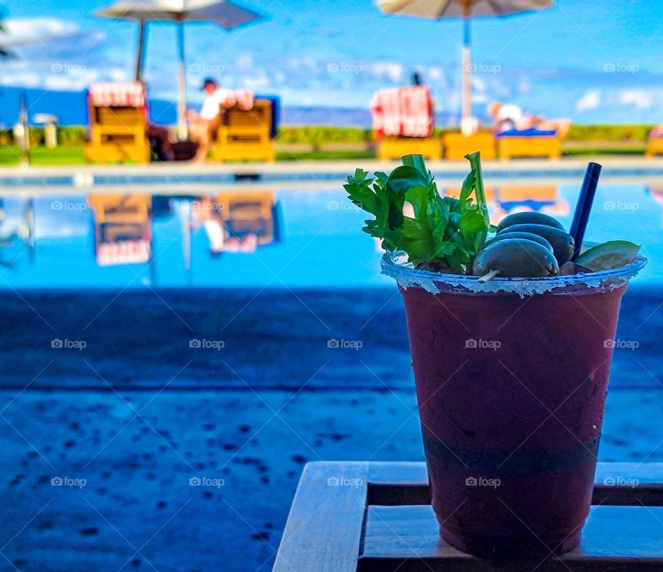 Bloody Mary poolside in Hawaii, with the ocean in view.  So peaceful and relaxing.