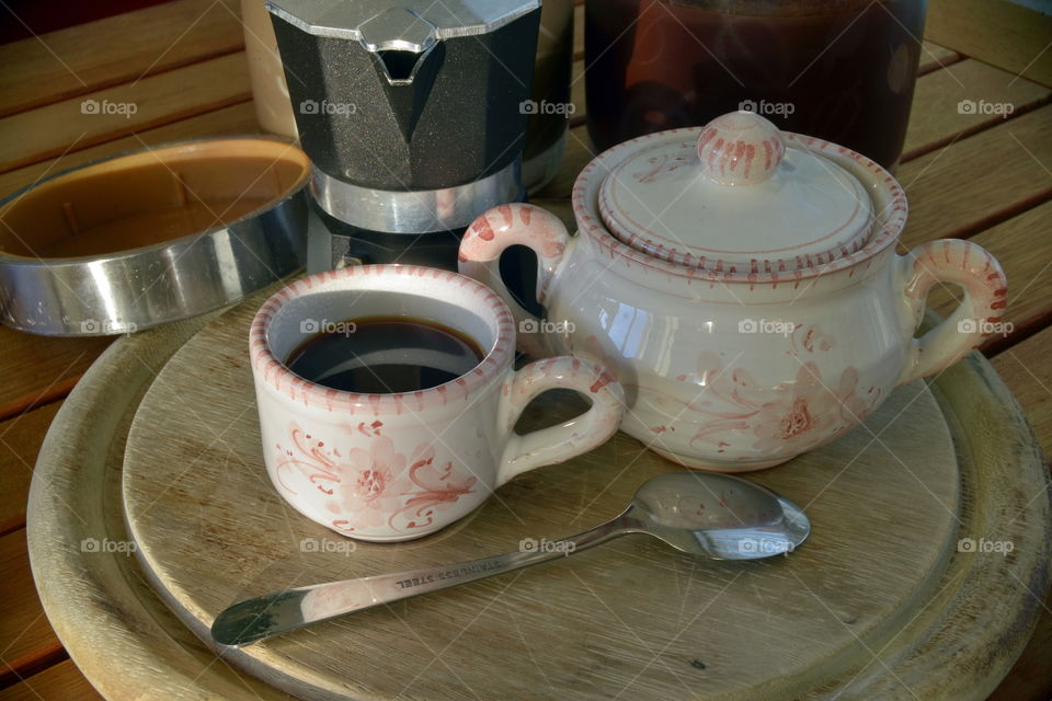 Close-up of coffee cup of wooden table