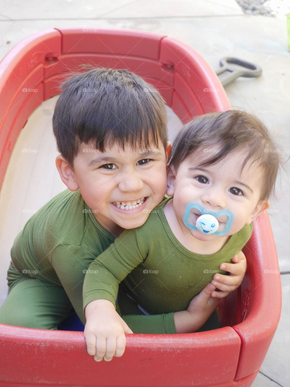 Brother sitting together in basket