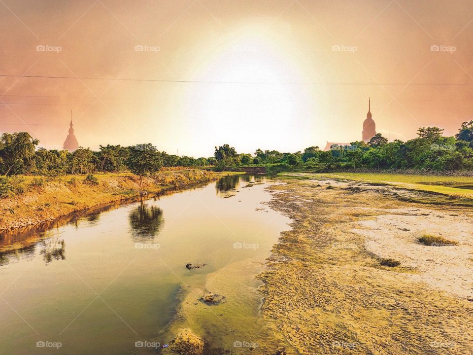 I took this picture of the river next to our house.  The picture of the river is very beautiful.  There is sun above the river.