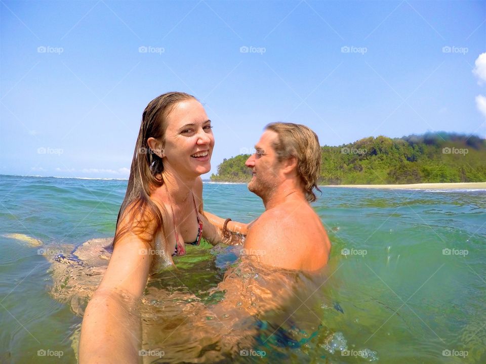 Couple playing in ocean