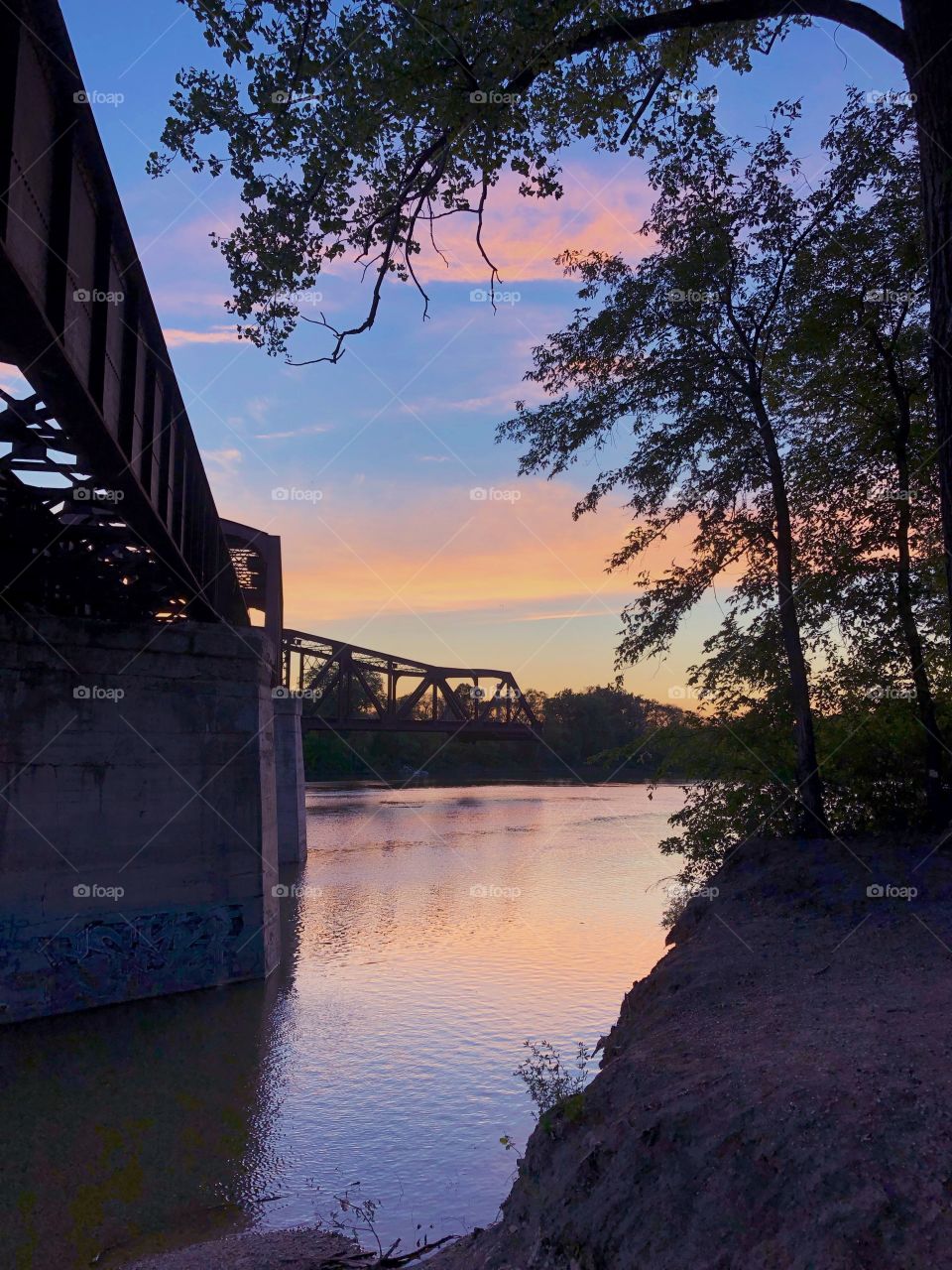 Sunset over an old train bridge 