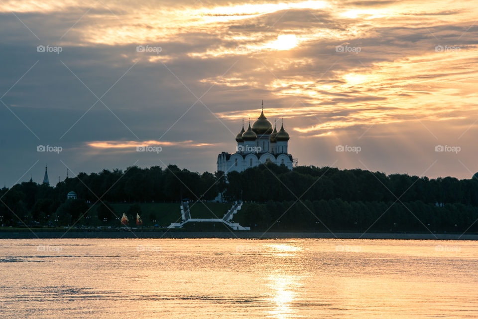 sunset with Russian church on the river bank