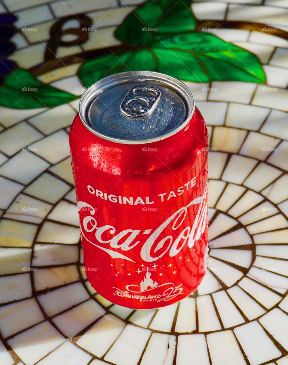 Coca cola can on garden table.