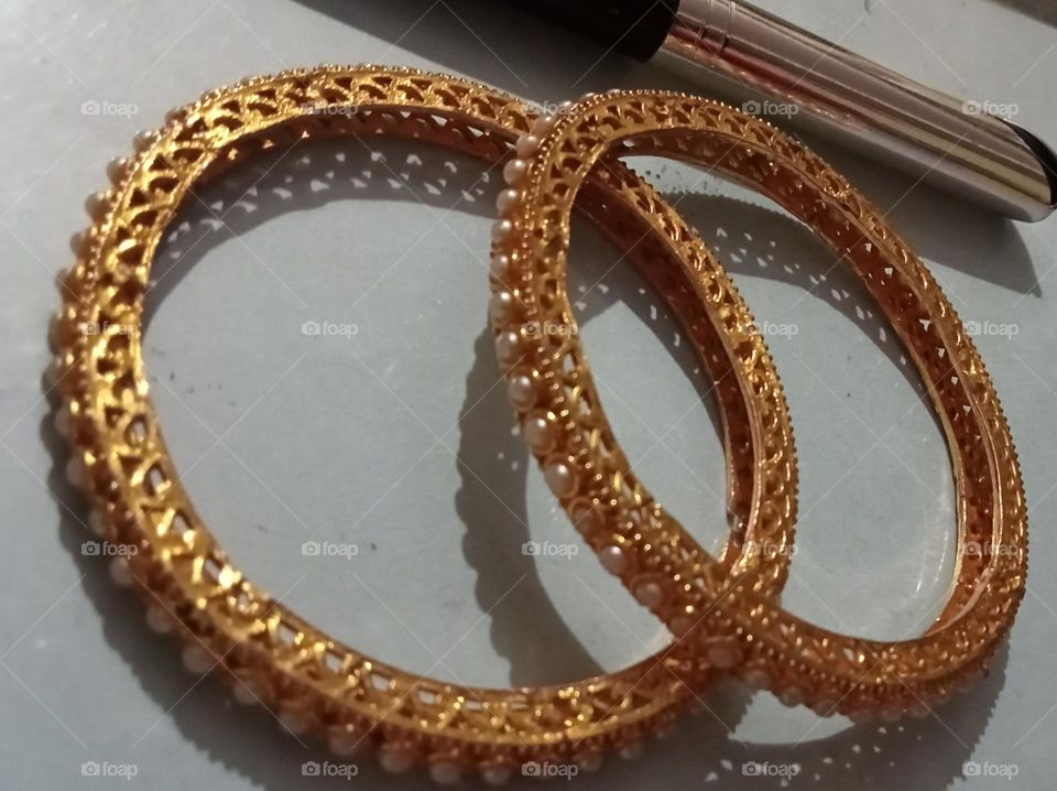 Beautiful close up photo of bangles. Indian women wearing this bangles any functions or daily wear. Bangles are in different different colours and sizes with beautiful designs.