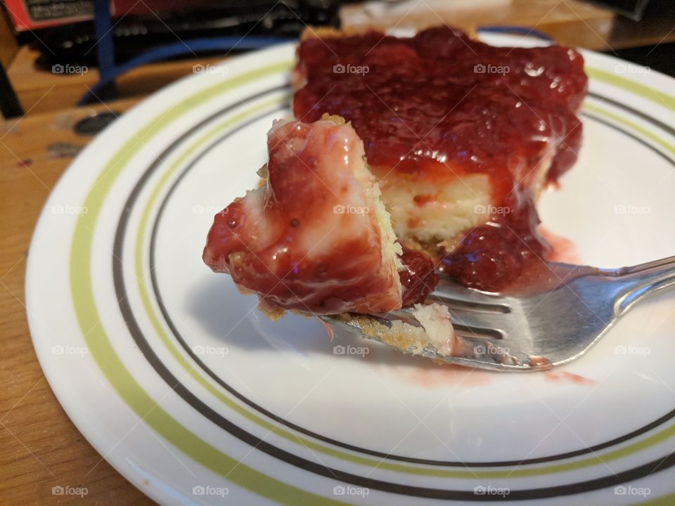 delicious cheese cake with strawberry sauce