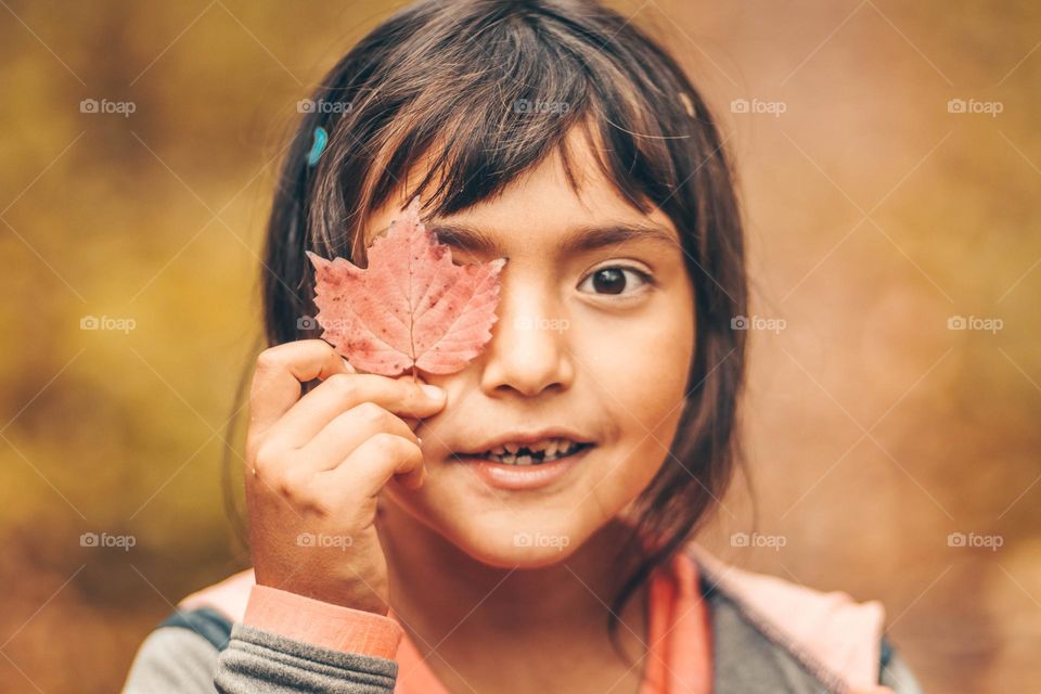 Cute hirl with an autumn leaf