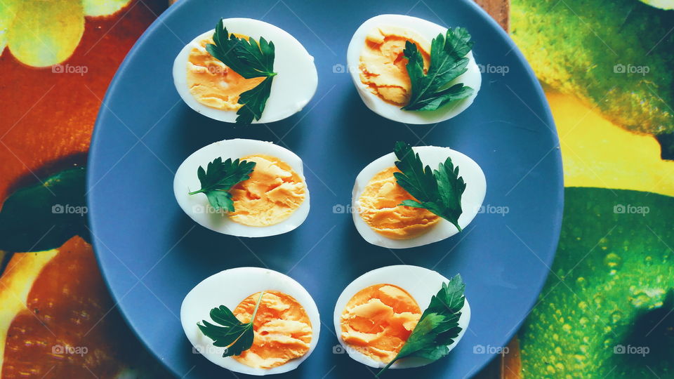 cut boiled eggs decorated with parsley