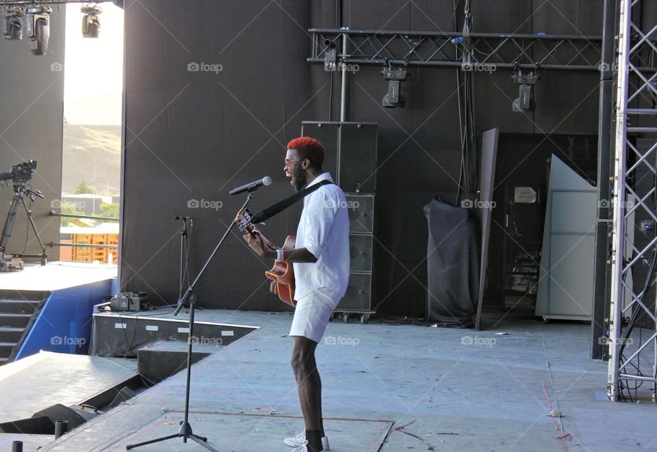 a man sings on stage a man sings on stage and plays the guitar