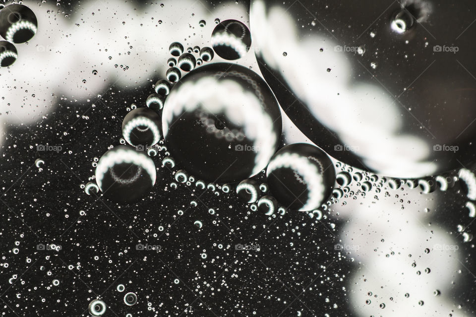 Small bubbles of vegetable oil in water close-up.