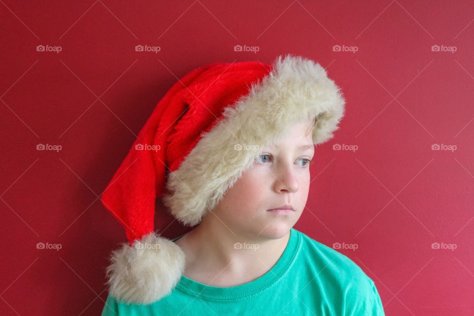 Portrait of serious boy with santa's cap