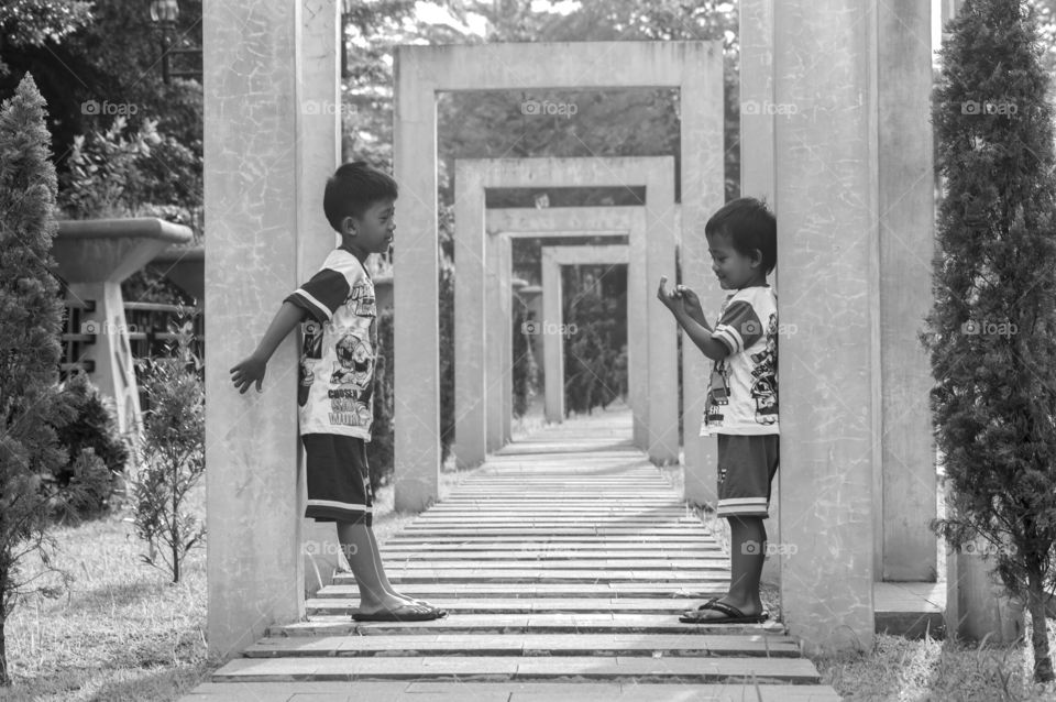 Brothers on walkway in park