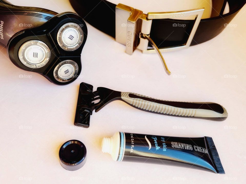 various shaving accessories including an electric razor, a razor blade and a shaving cream