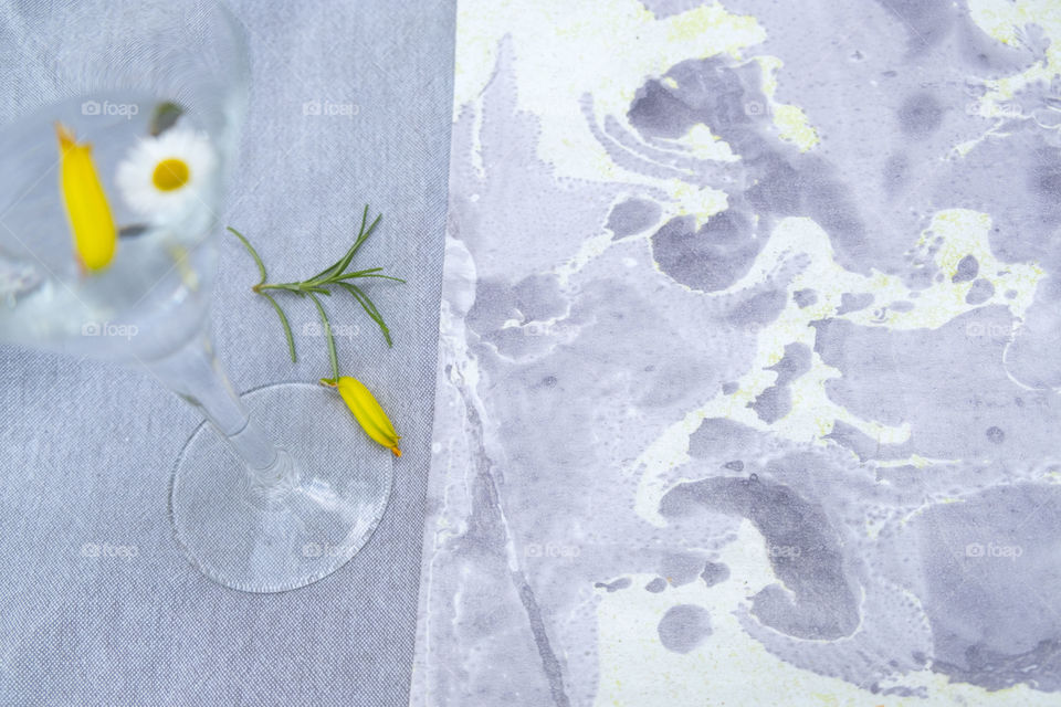 Marble paper, a glass and flowers