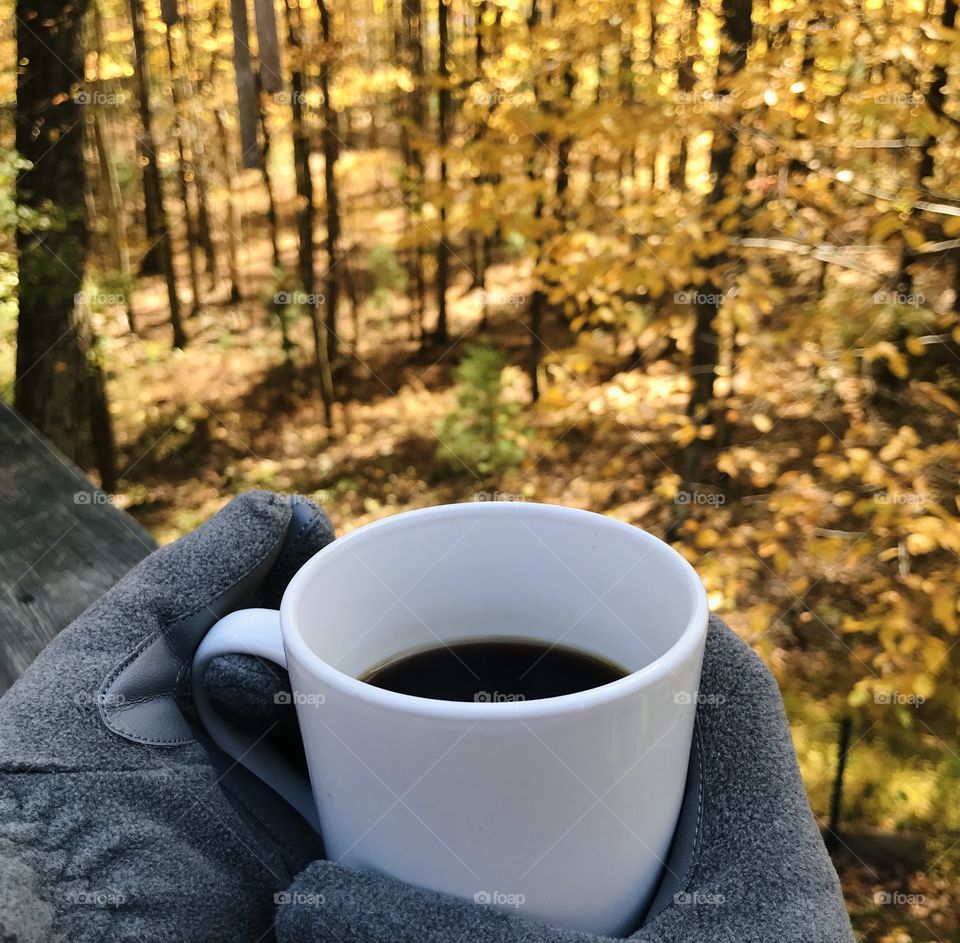 Warm cup of coffee and a golden view