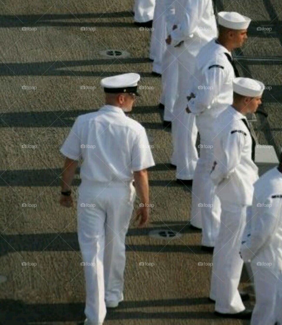 Navy Men manning the rails on a destroyer Navy ship
