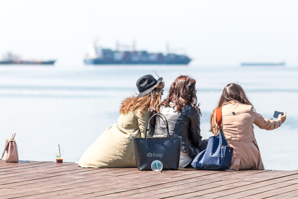 Friends Taking Selfie Using Mobile Phone At The Dock
