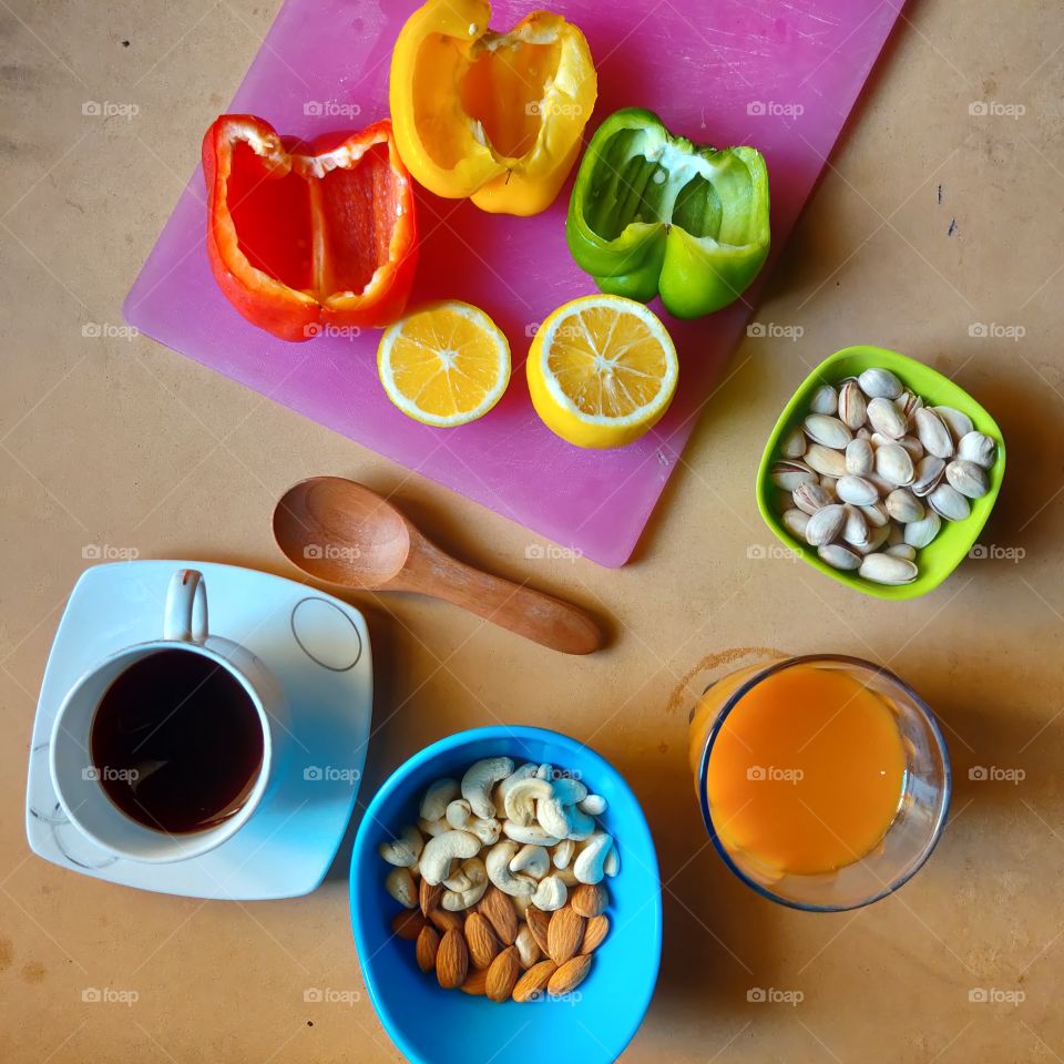colorful flat lay of coffee, dry fruits, veggies, juice and summer food