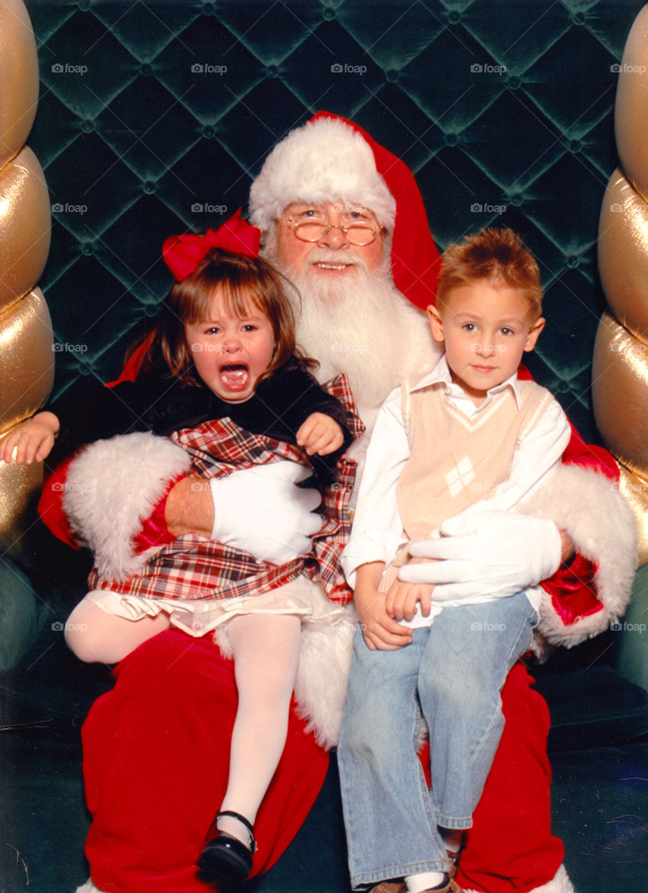 Santa Claus carrying two kids