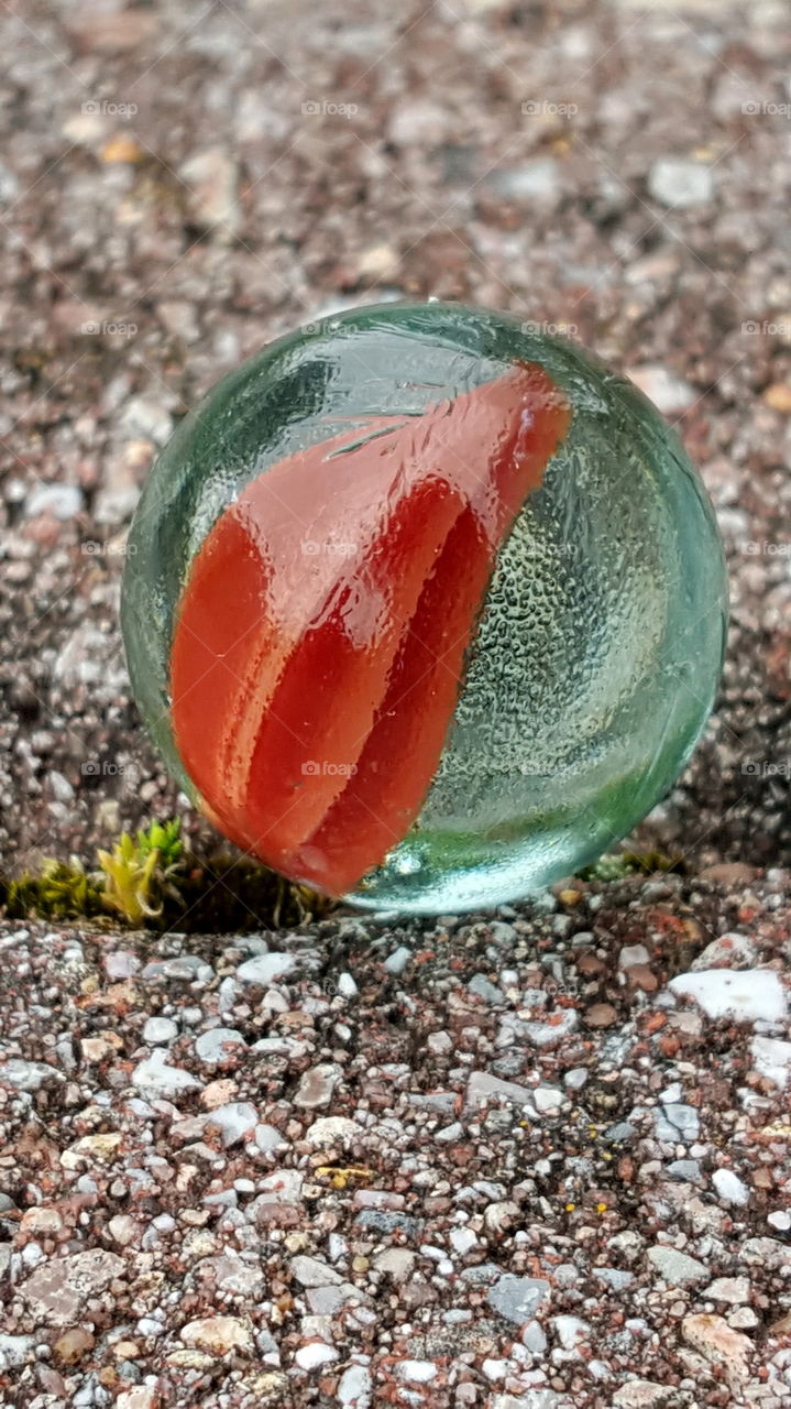 Glass marble shooter. Close up of swirled cat's eye glass marble shooter