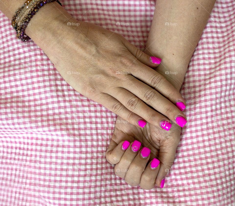 Female hands with pink manicure 
