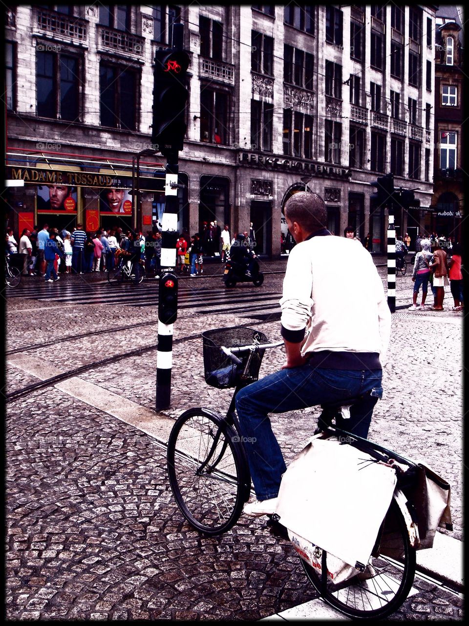 Man on a bicycle in Amsterdam city Holland traveling amazing colours waiting to go exploring