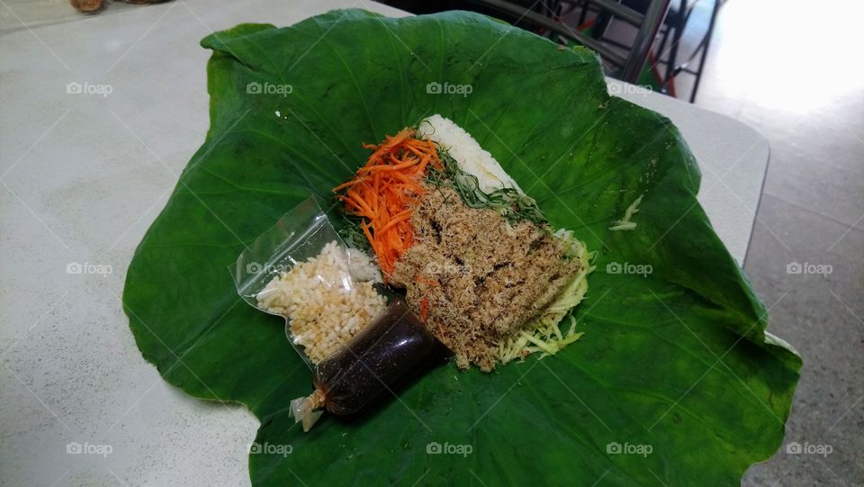 Traditional Southern Thai Rice top with Mixed Vegetables and Minced Fish with spicy and sour source called "Koaw Yum".