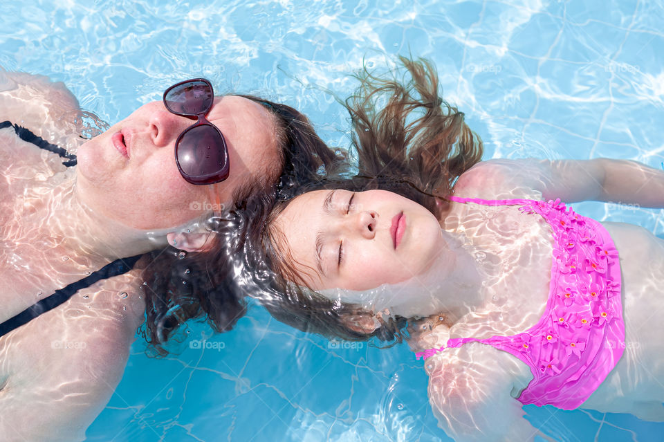 Relaxing in swimming pool.