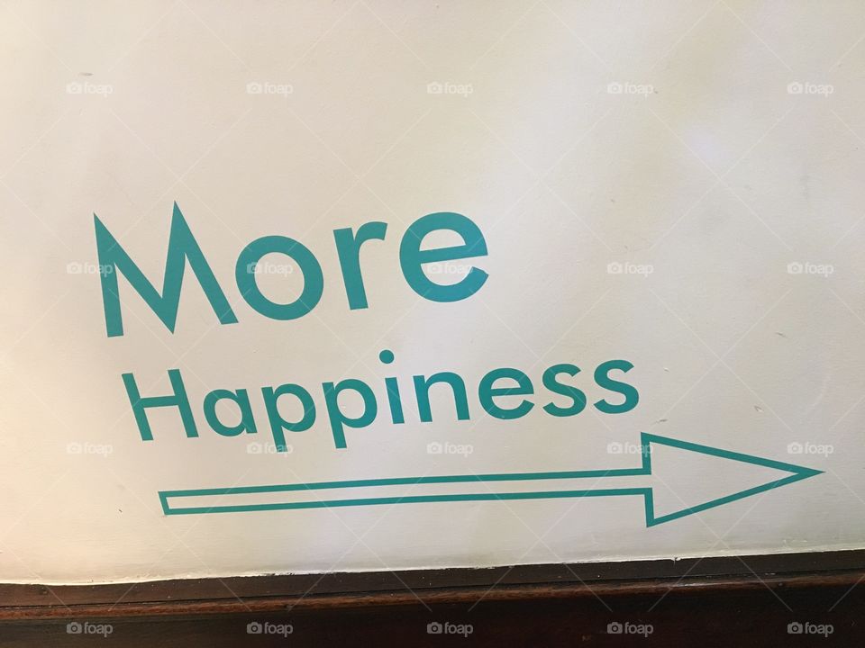 More Happiness ... sign found on a stairwell showing this way for more merchandise 