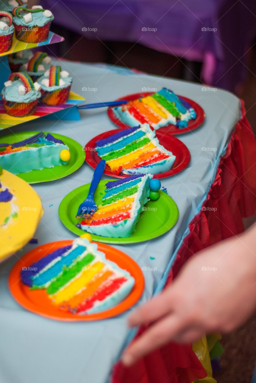 Rainbow Birthday Cake Sliced on Colorful Plates