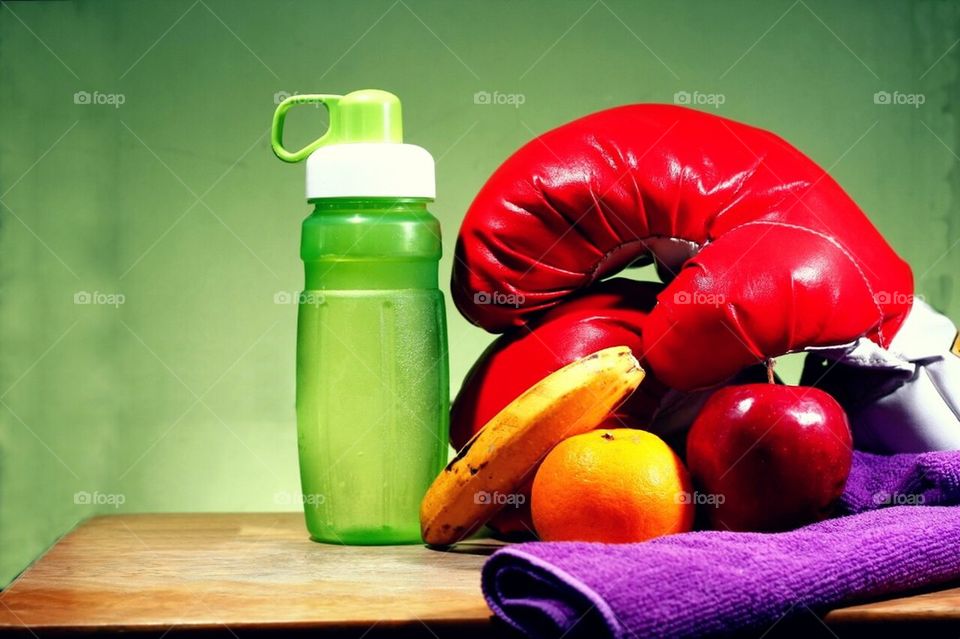 Water, fruits, towel and boxing gloves