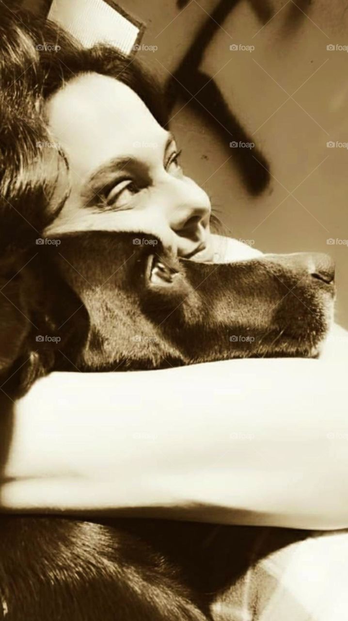 In a hug and through the looks we perceive the love between a dog and its caretaker.
