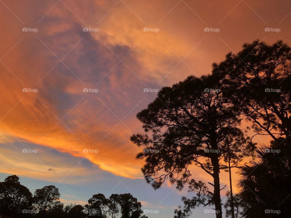 Stunning orange sunset illuminating the clouds. 