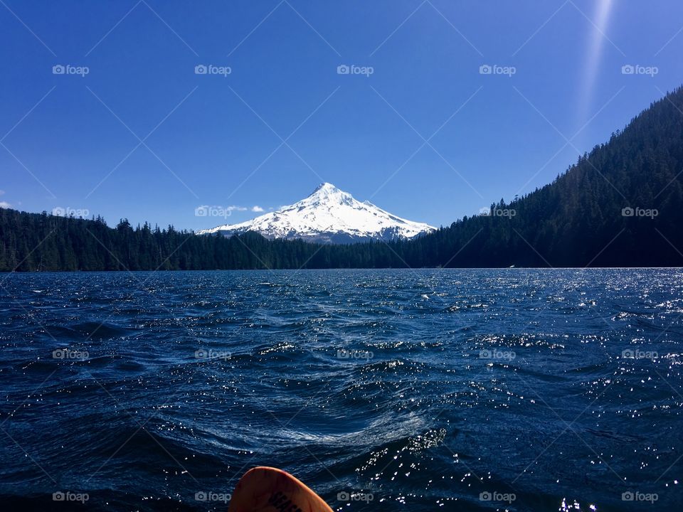 Kayaking near mount hood Oregon. The water Almost matches the sky. Mount hood still had quite a bit of snow on it. 