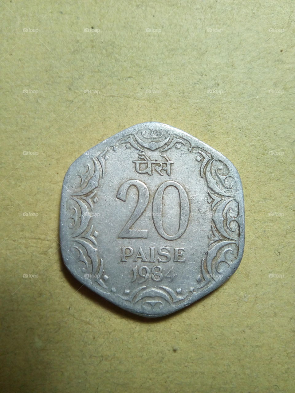 A coin of twenty paise- 1/5 share of Indian Rupee issued by Government of India in 1984.