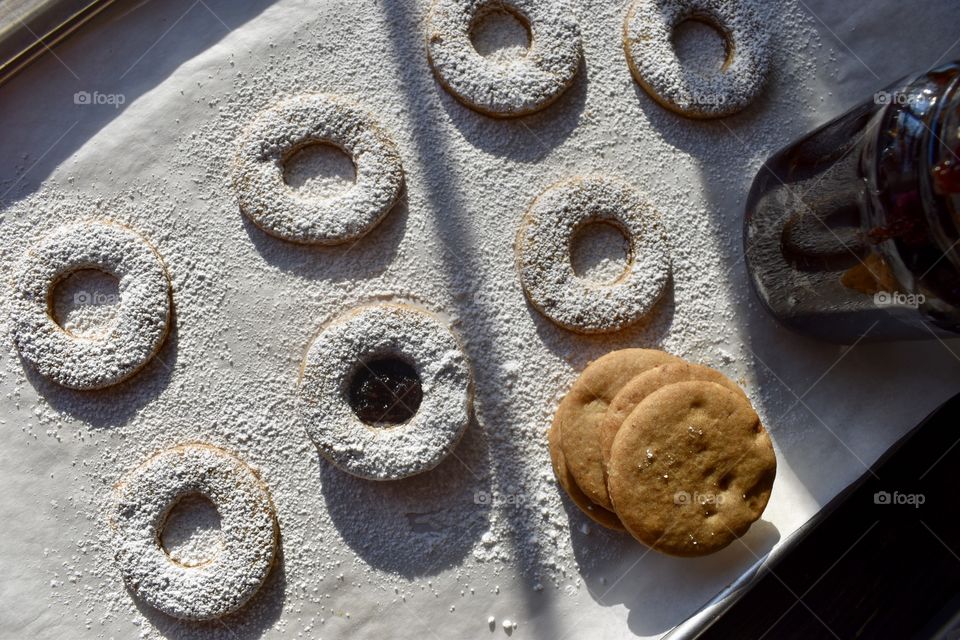 Top view of homemade linzer cookies sprinkled with powdered sugar