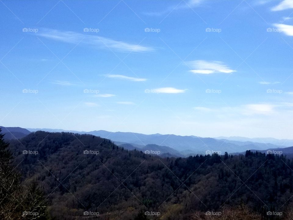 Breathtaking panoramic sweeping views of blue skies from Great Smoky Mountain national park/forest with rolling clouds over North Carolina & Tennessee.