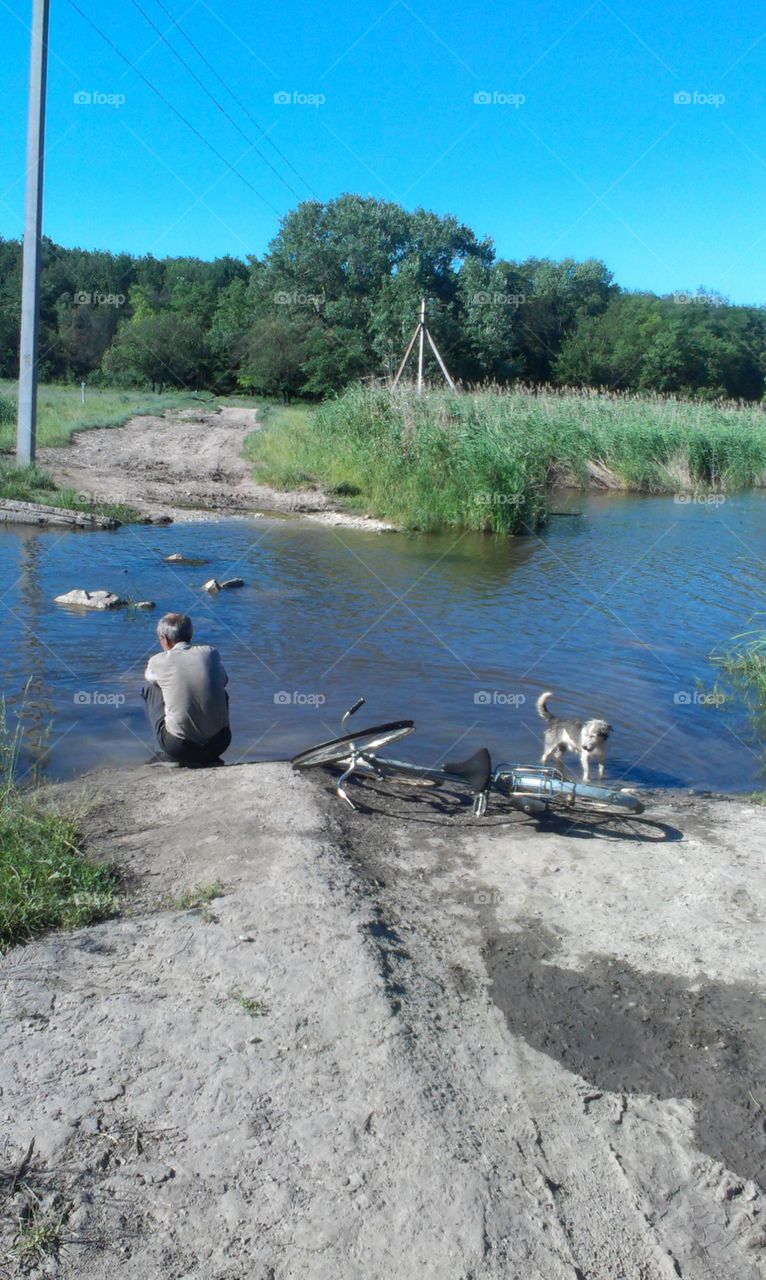 elder man with dog at the river 